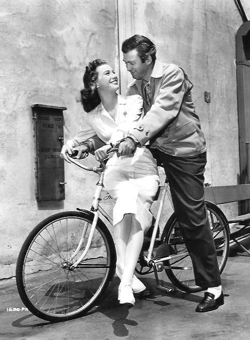 lars134:  Jimmy Stewart and Peggy Dow riding a bicycle behind the scenes of “Harvey”, 1950.