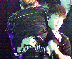  donghae picks henry up while singing blue tomorrow.    
