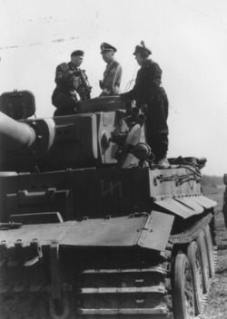 ifthisisaman:  Reichsfuehrer-SS Heinrich Himmler stands on top of a tank with two German soldiers, (USHMM) Unknown locale and date. 