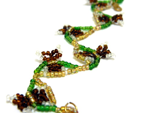  The sprightliest of nature’s children, zig-zagging amidst a garden of green and yellow beads;