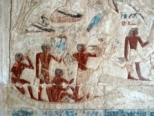 Ancient Egyptian painted relief showing men fishing on a small boat, from the mastaba of Nikausesi a