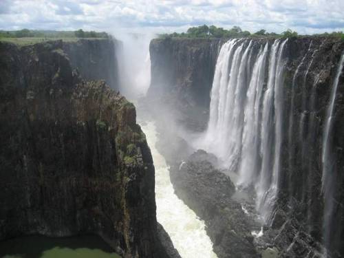 sixpenceee:  Victoria Falls lies on the border of Zambia and Zimbabwe. It’s the largest waterfall in the world. 