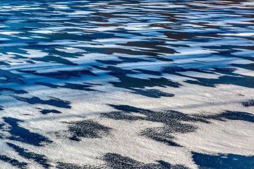 richherrmann:Wind, ice, snow and afternoon shadows created some abstract patterns on this pond near 