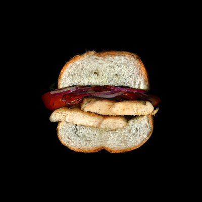 grilled chicken, roasted peppers, red onions, olive oil on a crusty roll