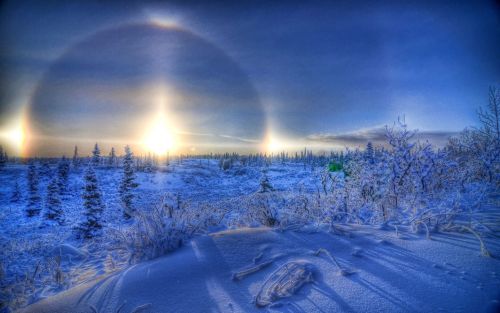 SUNDOG HALO Sundogs, also known as Mock Suns or Parhelia, are a pair of brightly coloured spots on e