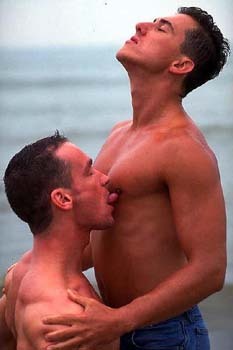 Nippleplay and licking on the beach.  For more gay nippleplay,