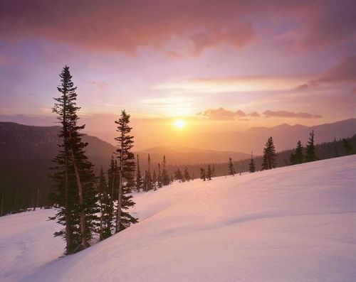 alexburkephoto:  For just a few moments a break in the clouds allowed the warm glow of sunrise light to spill onto the winter landscape.  The colors that happen when the low sun is refracted through light snow is otherworldly, but just moments later I