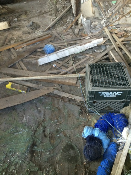 Yarn and broken glass on the floor of an abandoned house in Clarksburg, Ohio