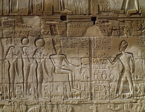 King Seti I making an offering to Amun, goddess Mut of Isheru, pictured as a lioness, god Khonsu and