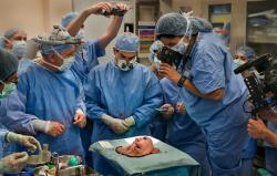 goldenpoc:  sixpenceee:  Sixteen hours into a transplant operation at the Cleveland Clinic in Ohio, surgeons finish the intricate task of removing the face from an organ donor (a woman who had died 3 days prior). Awed by the sight and by the gravity of