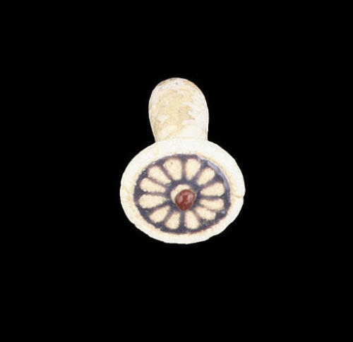 An Egyptian white glazed composition ear plug, NewKingdom, Dynasty XVIII. The disc-shaped terminal d