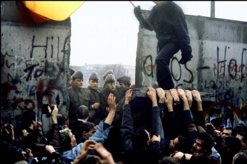 Protesters pulling down the Berlin Wall (November 9th, 1989).