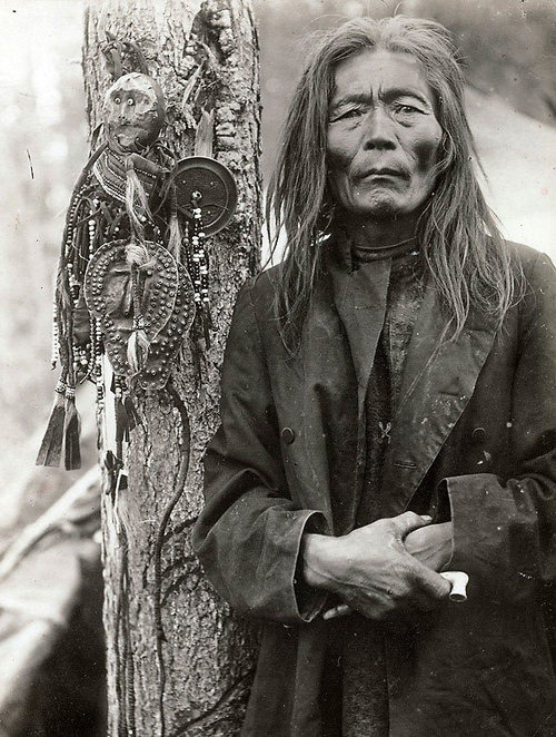 desert-dreamer:Evenk (Russian minority) shaman with a collection of shamanic objects, including imag