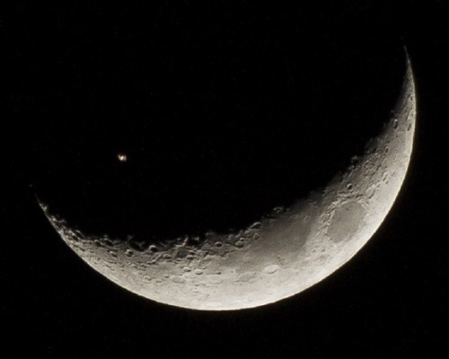 sixpenceee:The International Space Station crossing a crescent moon. (Source)