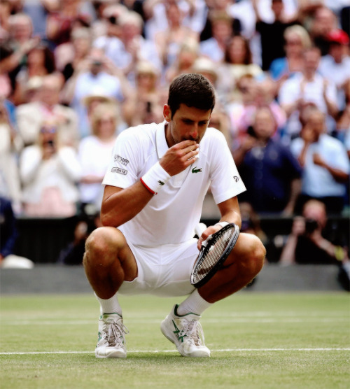 Novak Djokovic eats the Wimbledon grass after winning the 2019 tournament