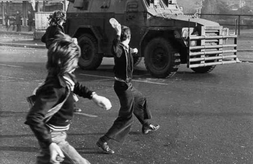 oglaighnaheireann:  Irish youths throw bottles at a British Army vehicle in the north of Ireland   1980s