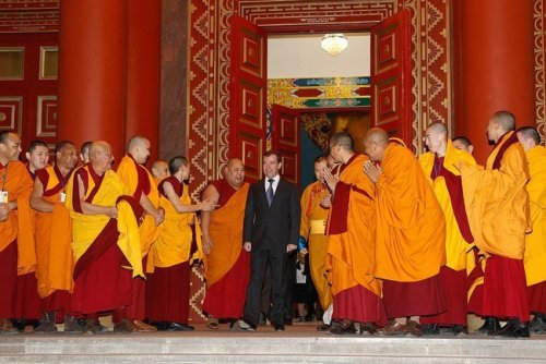 Buddhist monks welcome the (then) Russian President Dmitry Medvedev upon his arrival at the temple o