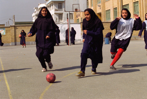 hopeful-melancholy:Girls play football in their school courtyard. Iran, 1998.A.Abbas
