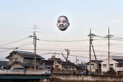 elanorpam:ofools:hollowedskin:shihlun:A giant helium balloon bearing the face of an ojisan (middle-a