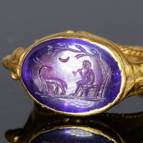 arthistoryfeed:Detail of a Roman amethyst intaglio depicting the god Pan playing the pipes underneat