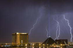 Lightning strikes behind the Mandalay Bay (L) and the Luxor hotel casinos as a thunderstorm passes through Las Vegas, Nevada early in the morning of September 11, 2011. (REUTERS/Steve Marcus)