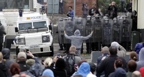 Youths clash with the Police Service of Northern Ireland (PSNI) riot police after trouble erupted in