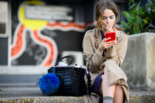 iPhone in red. Girl in trench