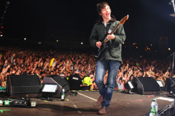 taces:  Alex Turner from Arctic Monkeys enjoying himself in front of their legendarily huge crowd at Lancashire cricket ground in July 2007. The size of the gig meant that it was compared to Oasis’ Knebworth. 
