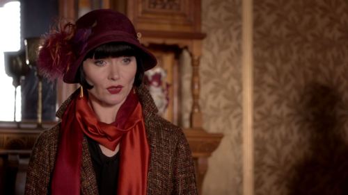 Miss Fisher’s sixth outfit worn in “Blood of Juana the Mad” (Season 2, Episode 8) is a rich brown tw