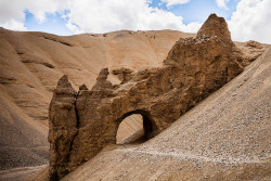 sandeepachetan:  A natural tunnel near Lachung la, Leh, India The 470km journey from Leh to Manali is studded with unbelievable rock formations like these. Opposite the motor-able road, this is probably part of the trekking route from Leh to Manali. We