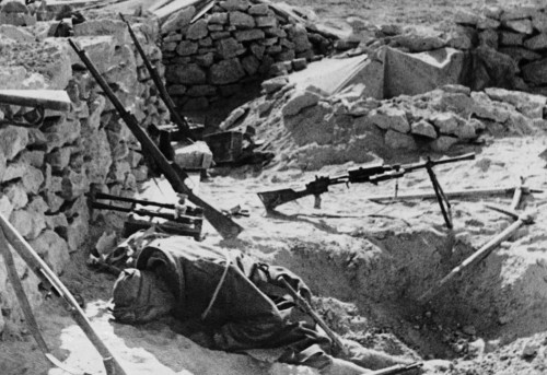 The body of an Italian soldier lies where he fell during battle, in astone-walled fort in the West L