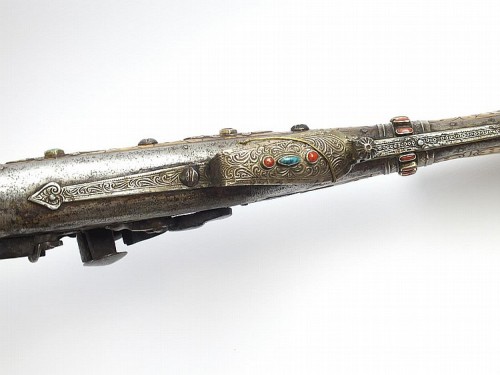A North African snaphaunce musket mounted with ivory and decorated with silver, turquoise, and red c