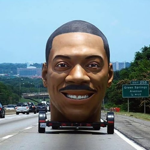 THE GIANT REPLICA HEAD OF EDDIE MURPHY ON WHEELS CANNOT SAVE YOU 