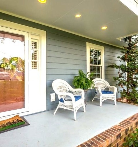 Mid-sized Traditional Brick Front Porch Design With An Addition To The Roof Mid-sized Classic Brick Front
