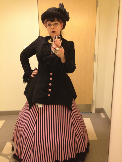 Goth at the Office: more pink & black. Batwing-hem jacket and lace jabot by the Infamous BlueJay, skirt by me. Vaguely awake expression thanks to two pots of tea AND a cup of coffee.