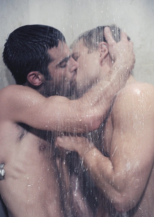 Gay men kissing each other