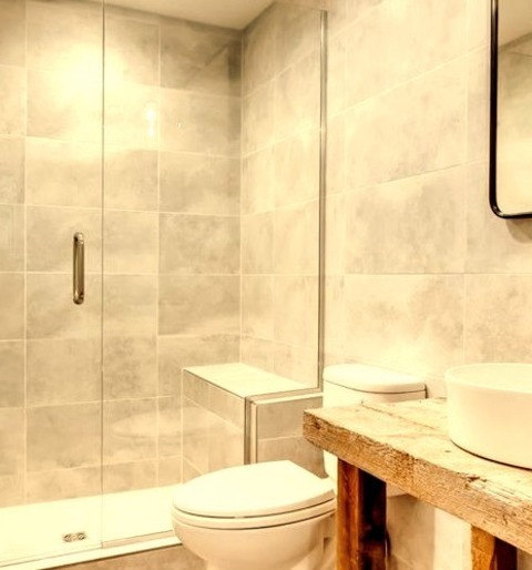 Basement - UndergroundA Large Underground Basement Design With A Light Wood Floor And A Beige Floor,
