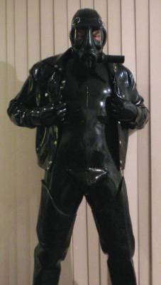 rubberhunk:  Invincible Rubber catsuit and jean-style latex jacket with gasmask and rubber gloves and waders. 