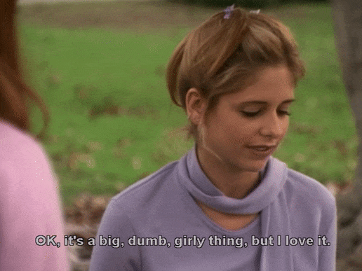 Buffy smiling and rocking her shoulders while saying, "Okay, it's a big, dumb, girly thing, but I love it."
