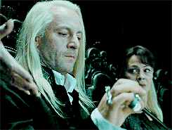 tyrionsansas:  Malfoy glanced sideways at his wife. She was staring straight ahead, quite as pale as he was, her long blonde hair hanging down her back, but beneath the table her slim fingers closed briefly on his wrist. At her touch, Malfoy put his hand