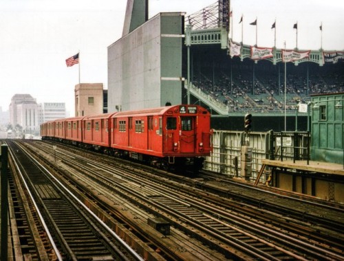 route22ny:  “A six-car train of tartar red ‘mainline’ R-36s has left the 161st Street-River Avenue station.  To the right is the original Yankee Stadium, The House That Ruth Built.  Old photos of this location show the elevated line but no Yankee