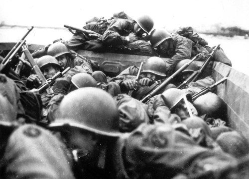 American soldiershuddle together aboard an assault boat as the cross the Rhine at SanktGoar while un