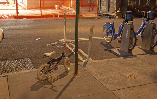 Model: Two Wheeler With Learner Wheels • City Streets • • Chained To Parking Sign • With City Bikes 