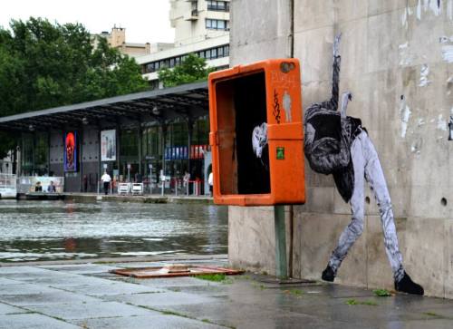 itsderandom:The French street artist known as Levalet, aka Charles Leval, works in Paris filling con