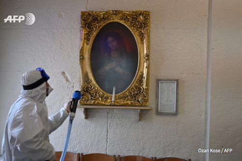 Worker with Istanbul’s Metropolitan Municipality disinfects the Panagia Altimermer Church, on March 