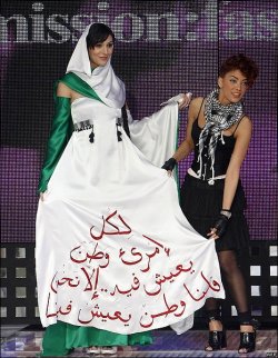 nadeemarouh:  Palestinian fashion designer Mirvat Ghandur shows off her winning dress in Lebanese TV talent show Mission Fashion, worn by winning model Sabrina Arab of Algeria. The inscription reads: “Everyone has a homeland to live in… except us,