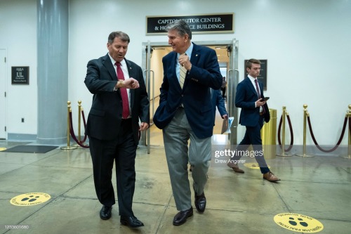 Sen. Mike Rounds (R-SD) walks with Sen. Joe Manchin (D-WV) as they head to a vote on some bill. I&rs