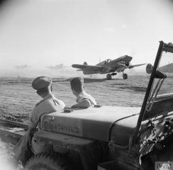 hms-exeter:    Army officers watch from their jeep as Curtiss Kittyhawk Mark IIIs of No. 112 Squadron RAF take off on a sortie at Foggia, Italy. Source 