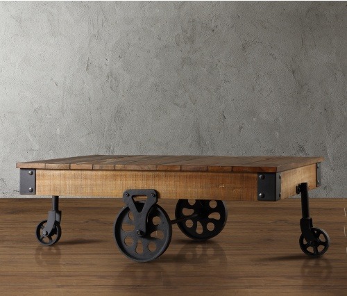 An industrial coffee table with wheels.