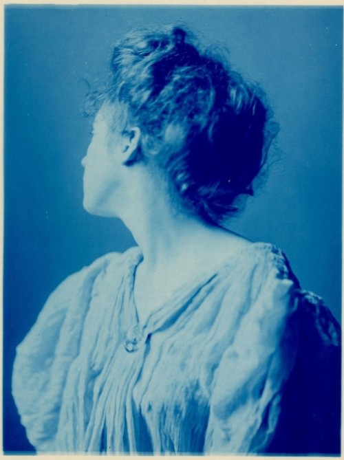 rivesveronique:1900 Cyanotype photo of a woman with her head turned.